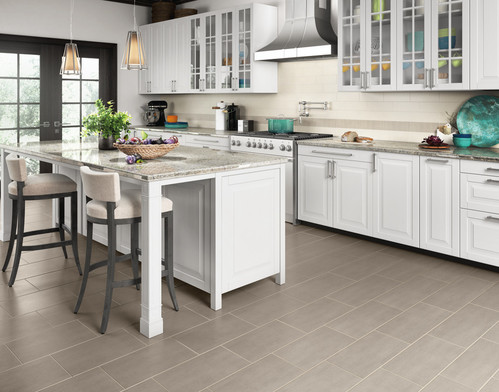 Tile flooring in the kitchen with white cabinets 
