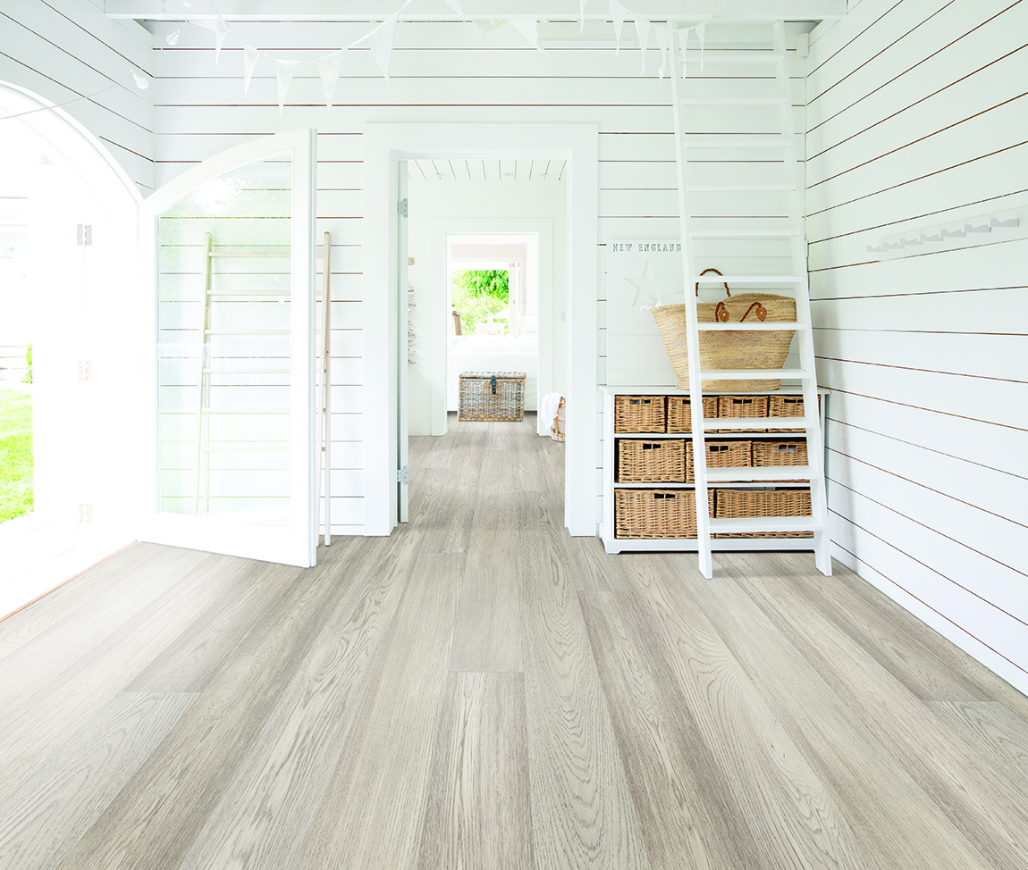 Light oak hardwood floor in porch setting with white shiplap walls, French doors leading outside